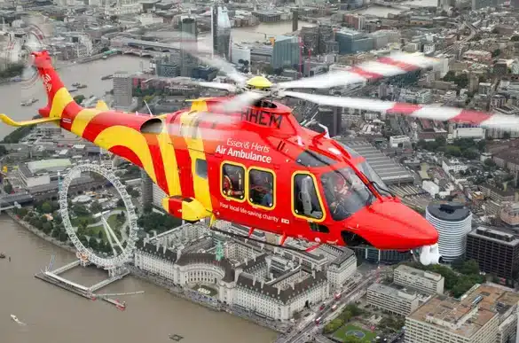 Essex and Herts Air Ambulance flying over London