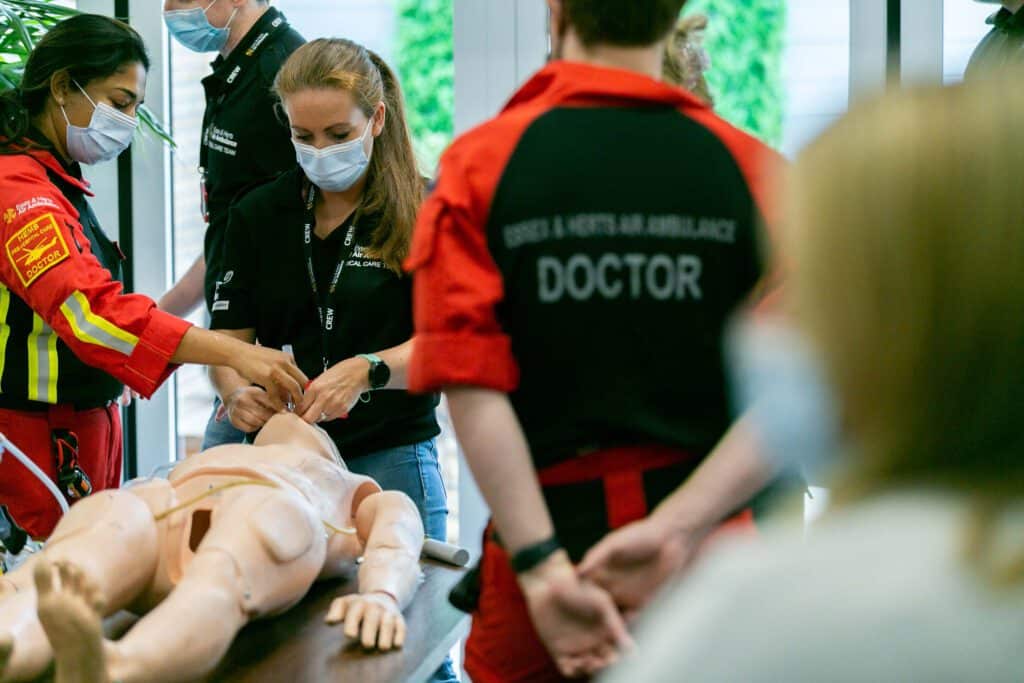 EHAAT Doctors teaching workers CPR on the practice mannequins