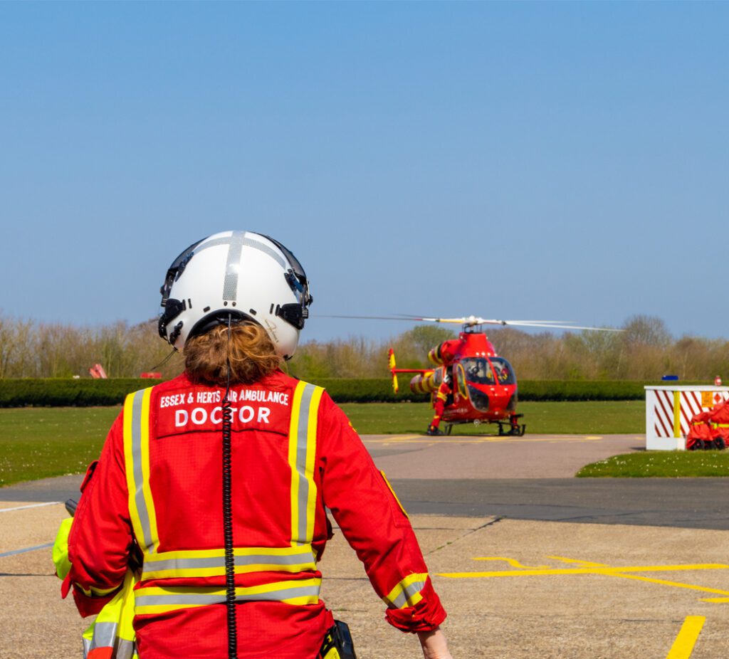 Pre-hospital doctor walking towards the MD902 for a mission