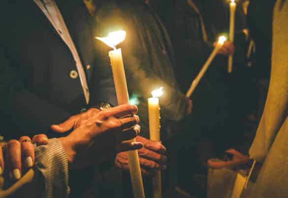Woman holding a candle at night, during the Easter celebrations